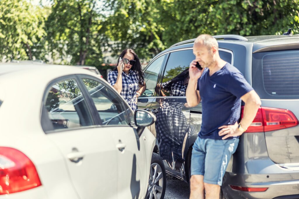 Driver reviewing insurance paperwork after a car accident, considering whether to file a claim when not at fault